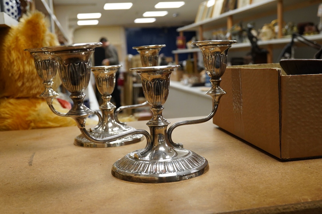 A pair of Elizabeth II silver mounted two branch, three light dwarf candelabra, by George Howson, Sheffield, 1959, height 16.7cm, weighted.